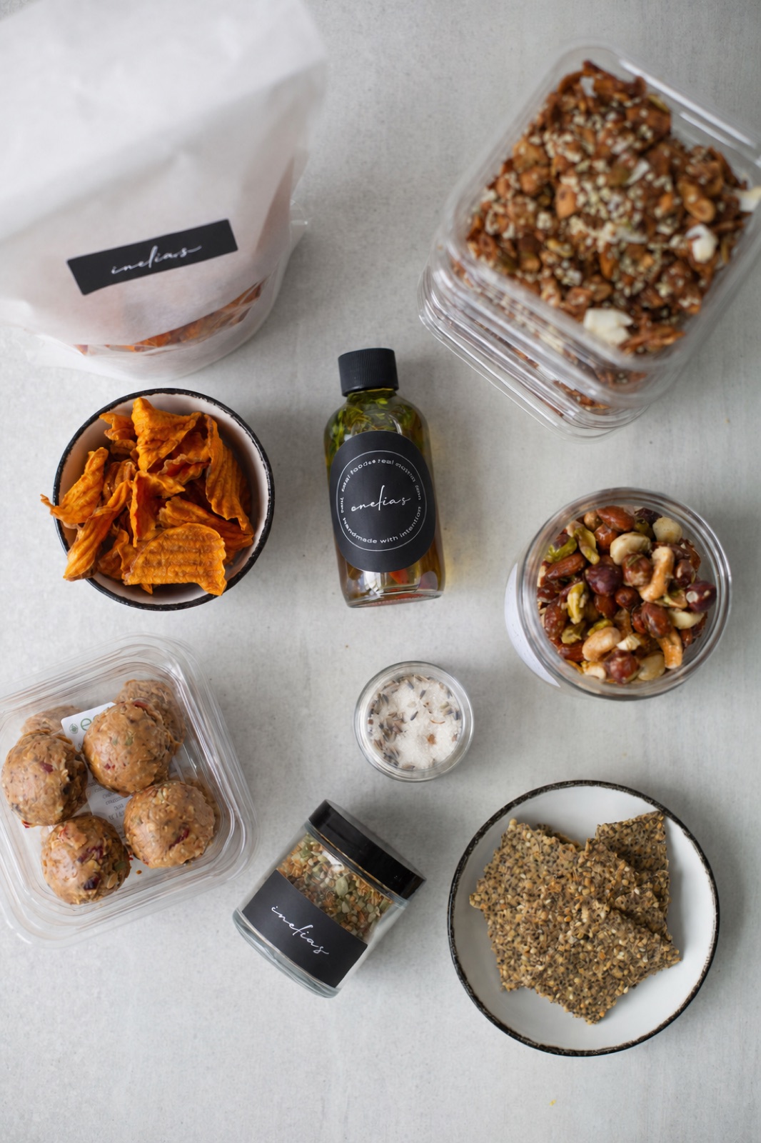 Overhead of Amelia's market goods: house granola, oils, salts and root chips