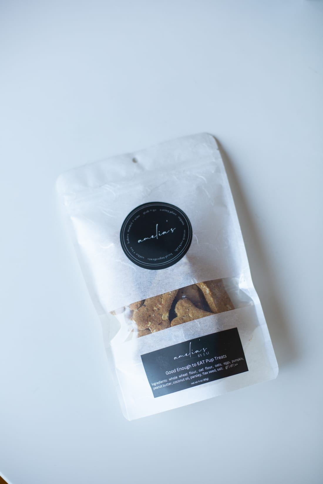 The Good Enough to EAT pup treats bag, with its ingredient label readable