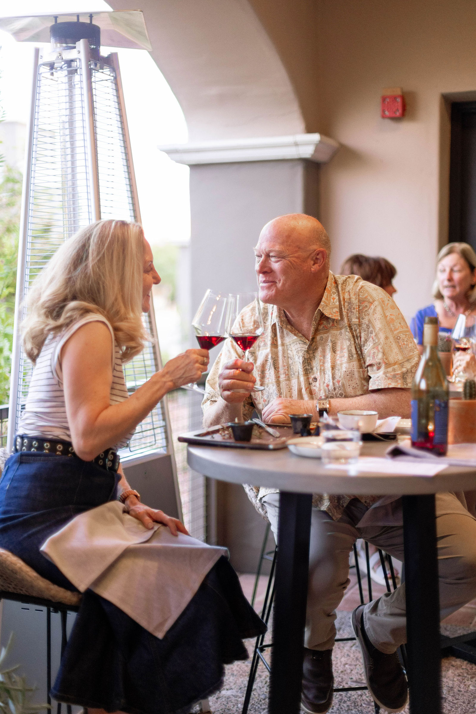 Wine club members raising a glass of red wine together at Amelia's in Scottsdale